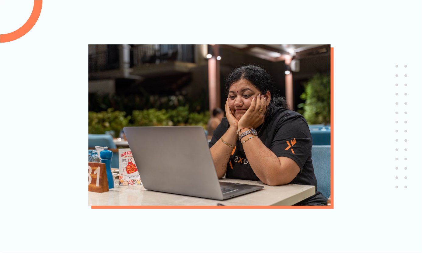 A team member sitting in front of her computer looking sad